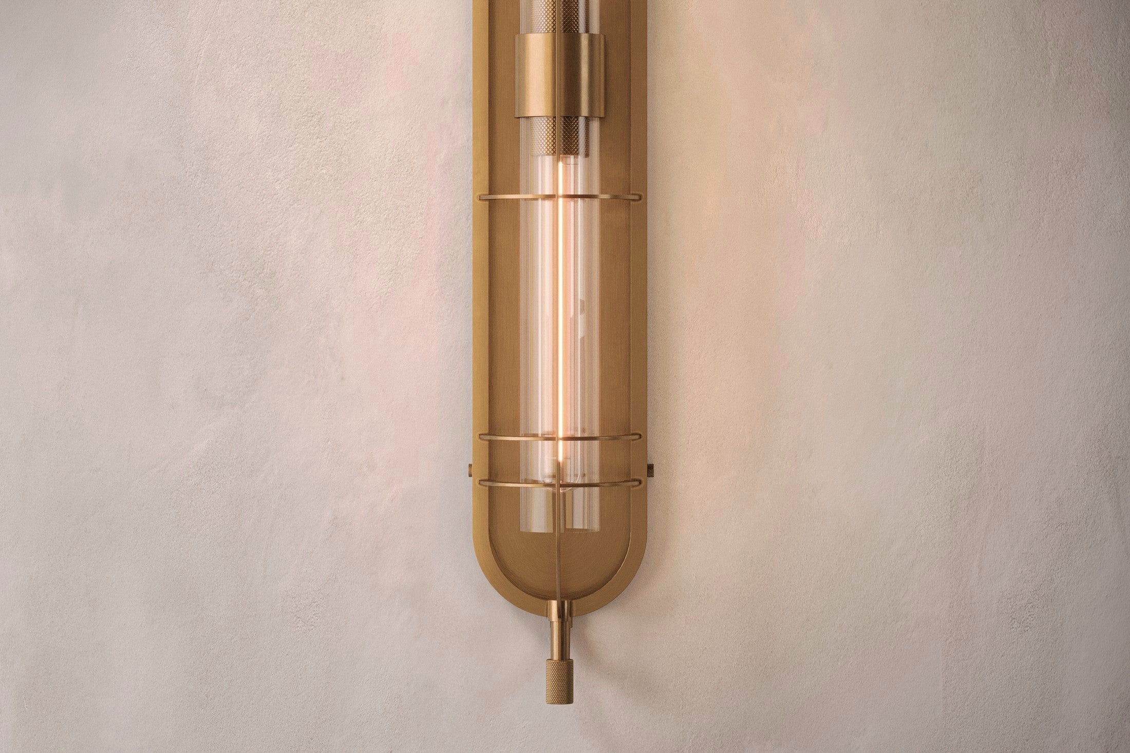 Close-up of the Astragal Sconce, a modern wall sconce featuring hand-finished solid brass and glass.