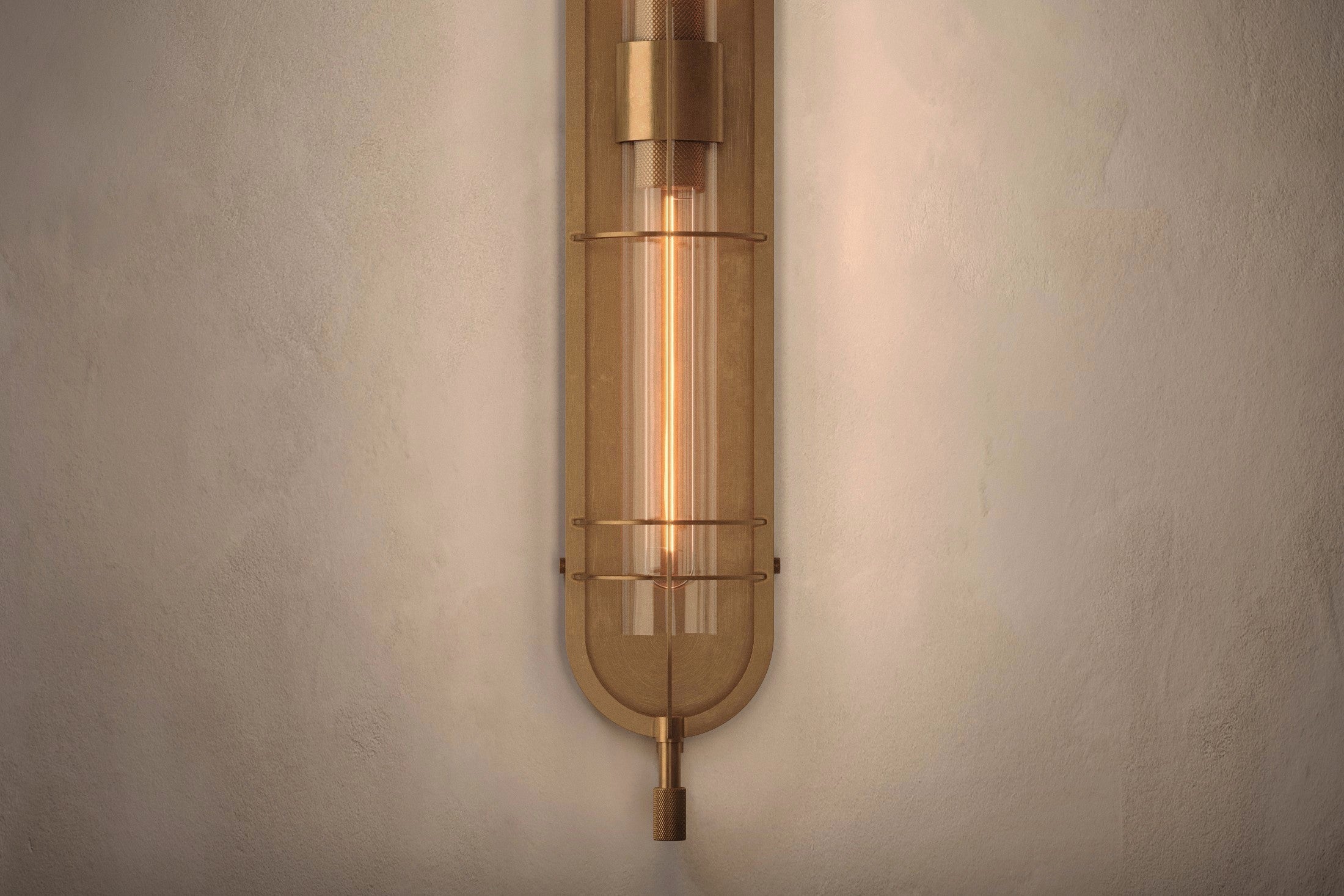 Close-up of the Astragal Sconce, a modern wall sconce featuring hand-finished solid brass and glass.