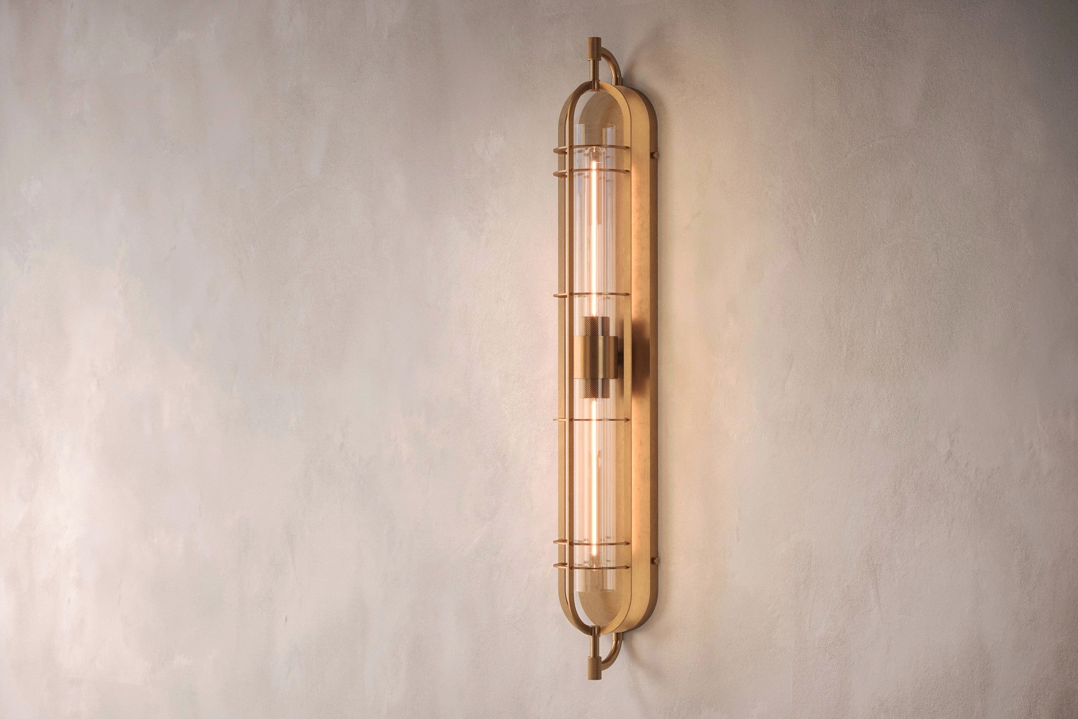 Architectural lighting featuring the Astragal Sconce, a modern wall sconce in hand-finished solid brass and glass.