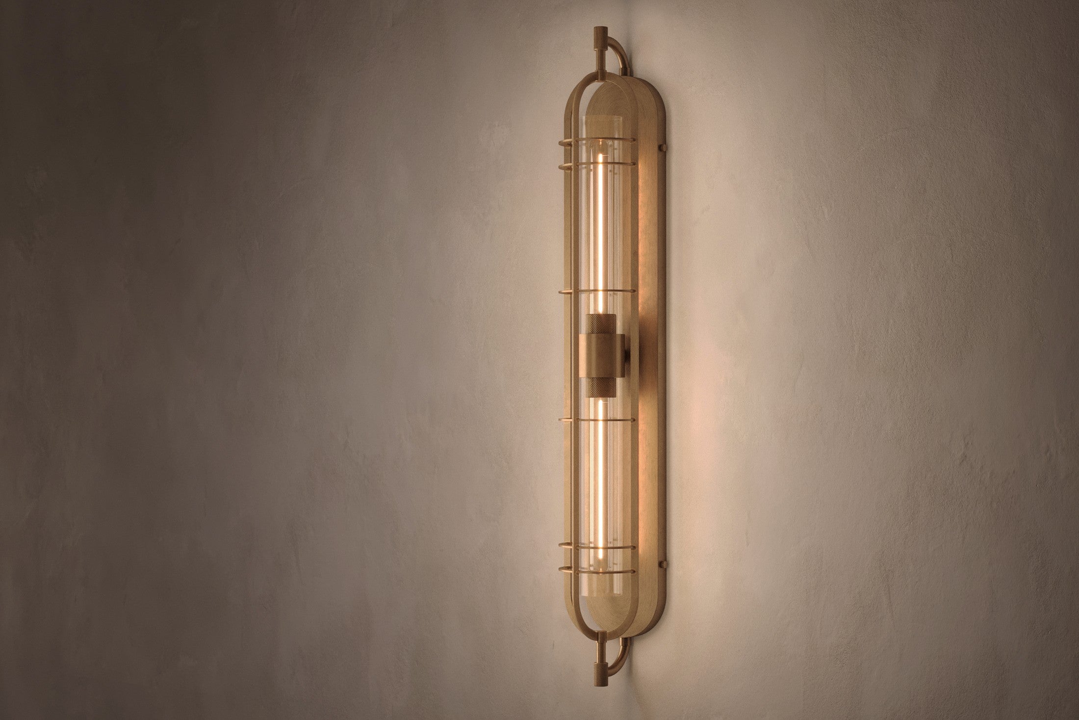 Modern architectural lighting featuring the Astragal Sconce, a wall sconce in hand-finished solid brass and glass.