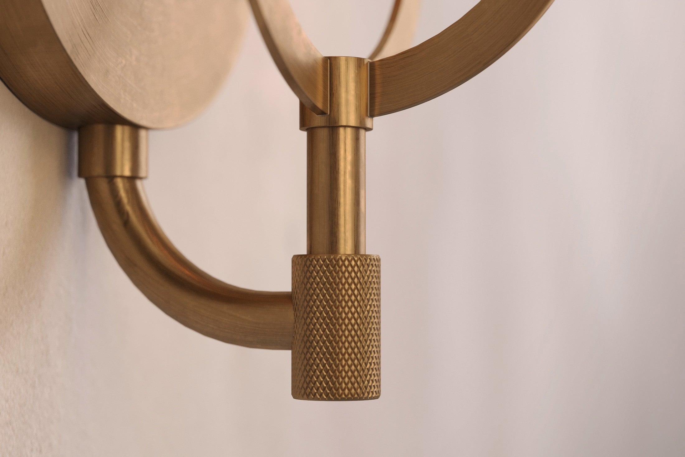 Close-up of the Astragal Sconce, a modern wall sconce featuring hand-finished solid brass and glass.