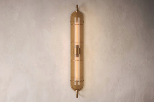 Designer lighting featuring the Astragal Sconce, a modern wall sconce in hand-finished solid brass and glass.