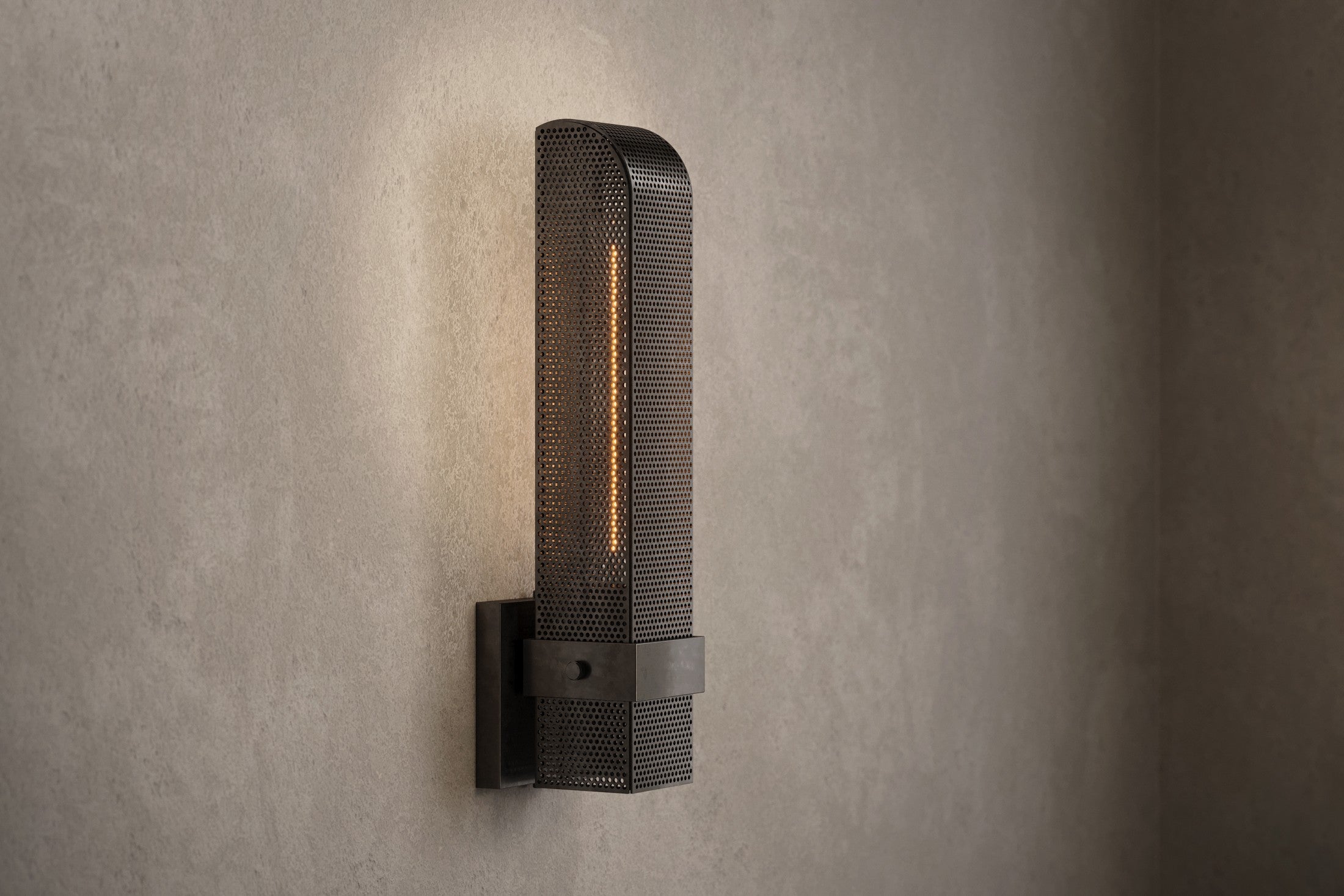 Architectural lighting featuring the Baffle Sconce, a modern wall sconce in hand-finished perforated metal.