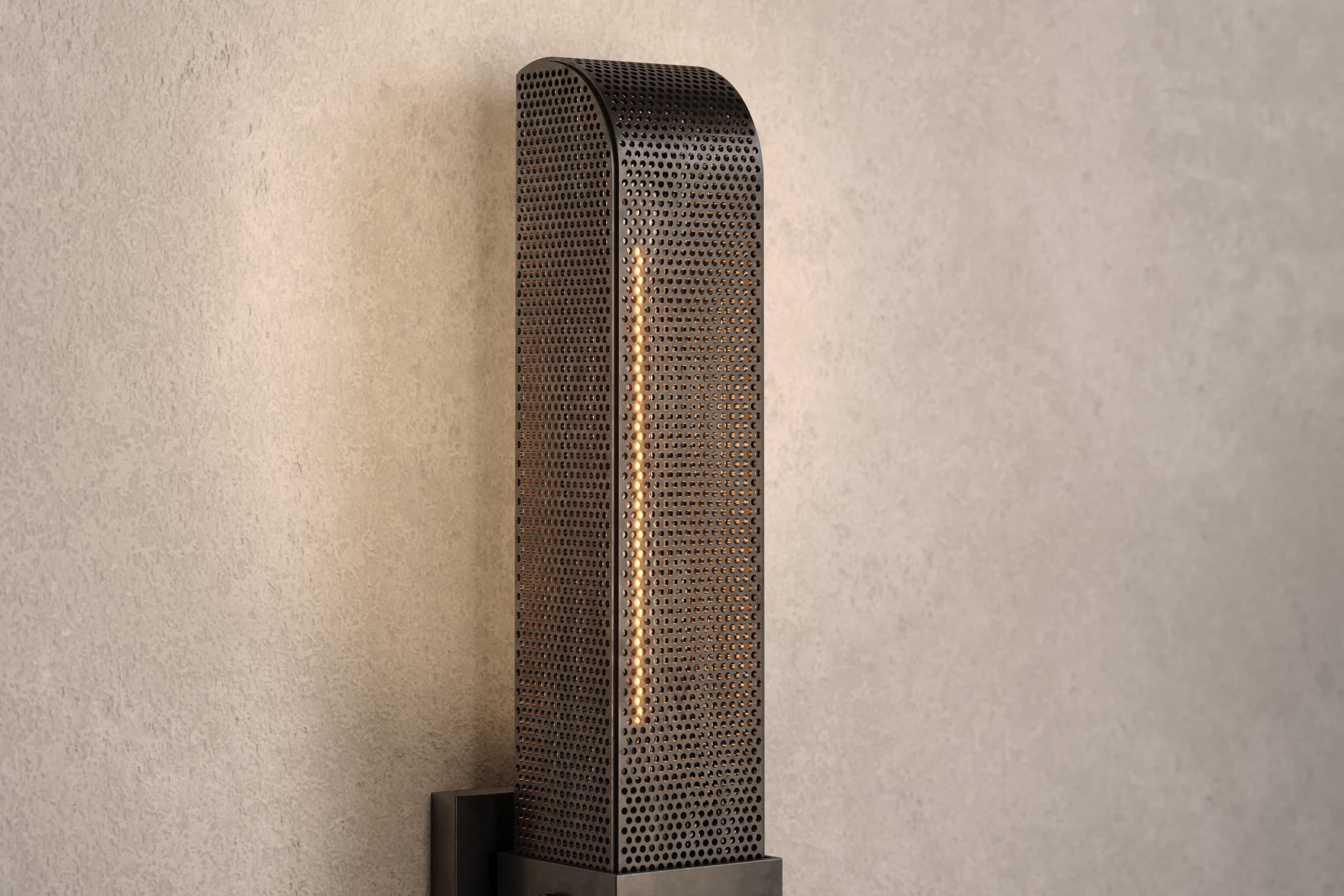 Close-up of the Baffle Sconce, a modern wall sconce featuring hand-finished perforated metal.