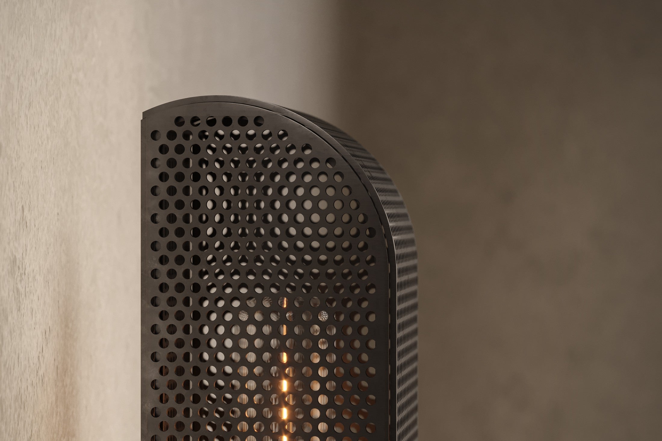 Close-up of the Baffle Sconce, a modern wall sconce featuring hand-finished perforated metal.