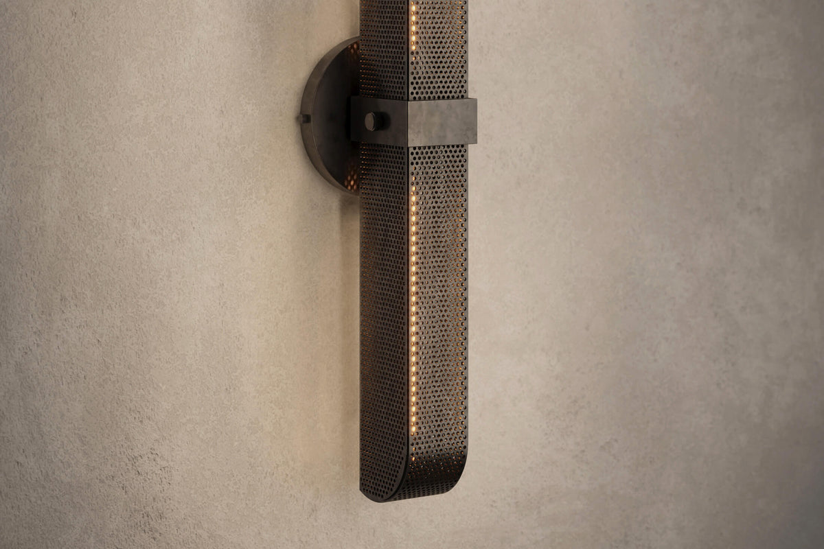 Close-up view of the designer Baffle Sconce (Tandem), an industrial-inspired wall light featuring hand-finished perforated steel for genuine, utilitarian elegance.