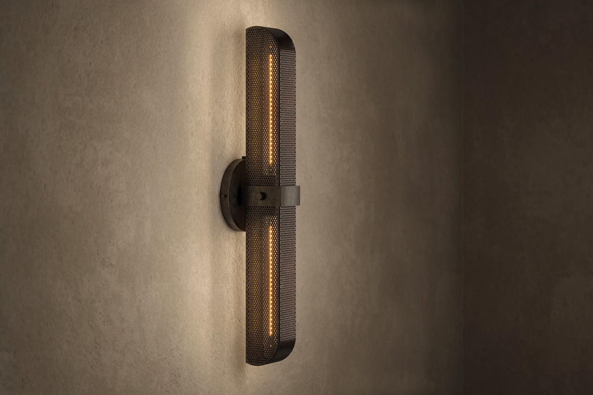 Angled view of the architectural designer Baffle Sconce (Tandem), an industrial-inspired wall light featuring hand-finished perforated steel for genuine, utilitarian elegance.