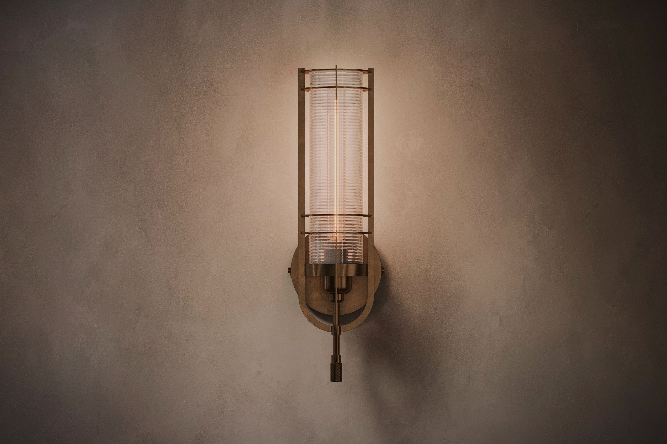 Modern designer lighting featuring the Batten Sconce, a wall sconce in hand-finished solid brass and ribbed glass.