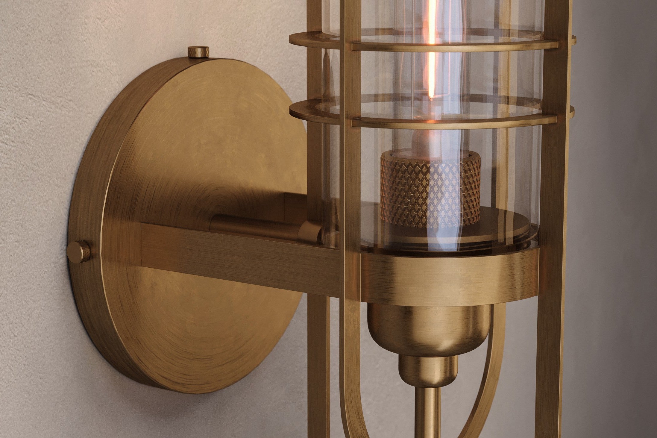 Close-up of the Batten Sconce, a modern wall sconce featuring hand-finished solid brass and ribbed glass.