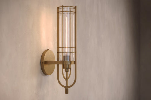 Architectural lighting featuring the Batten Sconce, a modern wall sconce in hand-finished solid brass and ribbed glass.