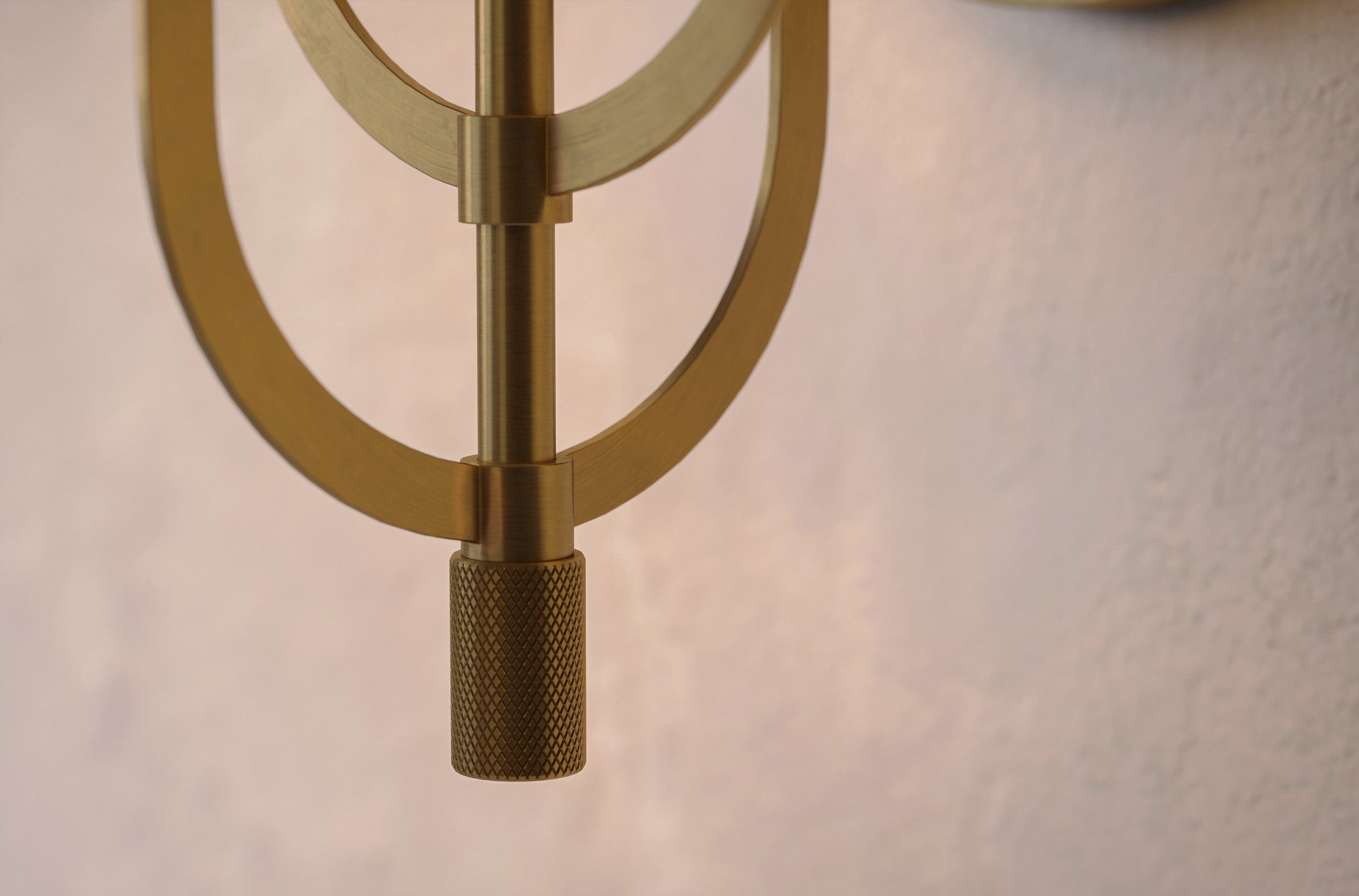 Close-up of the Batten Sconce, a modern wall sconce featuring hand-finished solid brass and ribbed glass.
