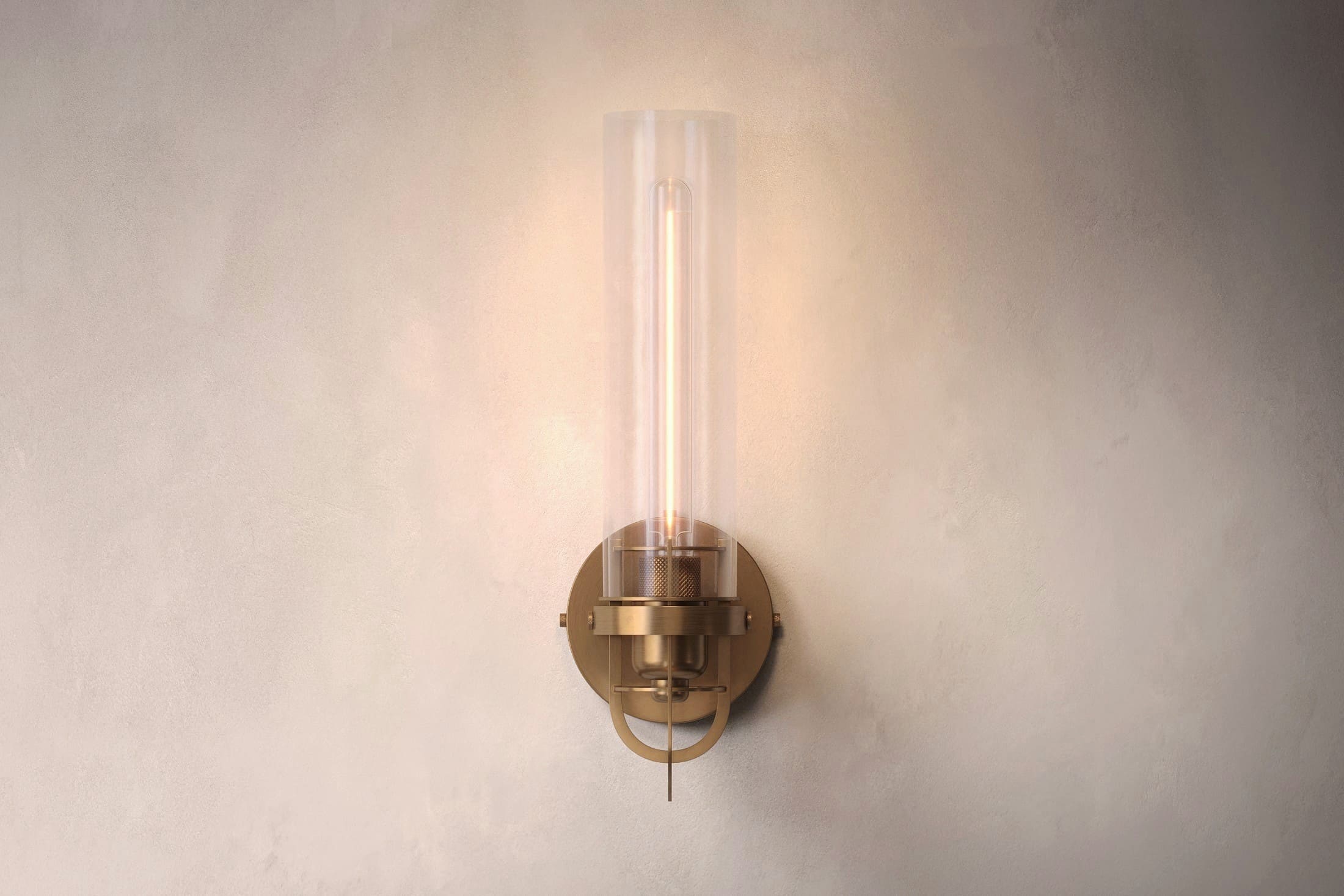 Designer lighting featuring the Beacon Sconce, a modern wall light in hand-finished solid brass and a heavy glass cylinder.