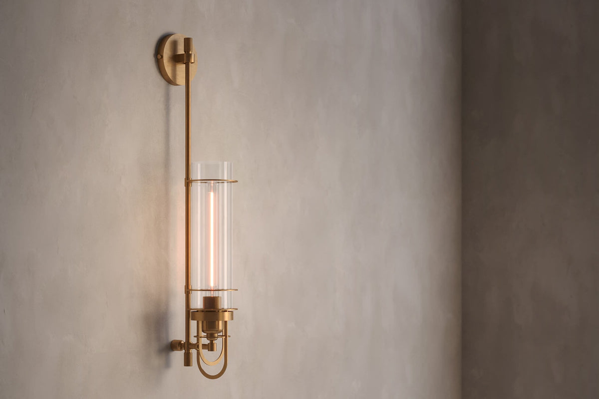 Angled view of the designer Belay Sconce, a nautically-inspired wall light featuring hand-finished solid brass and heavy glass for authentic, artisanal elegance.