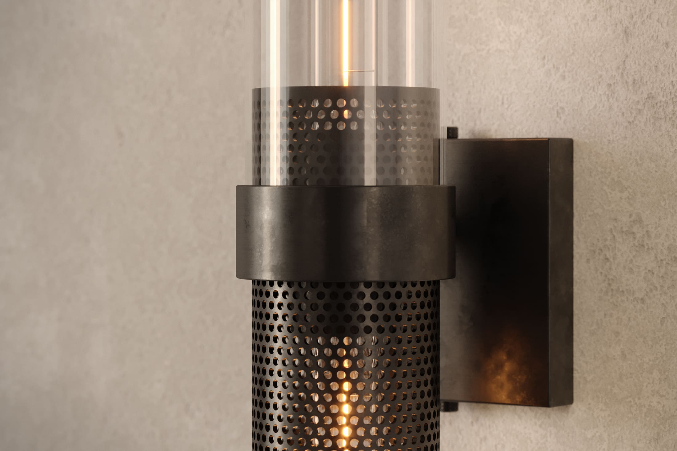 Close-up of the Carbide Sconce, a modern wall sconce featuring hand-finished perforated metal and glass.