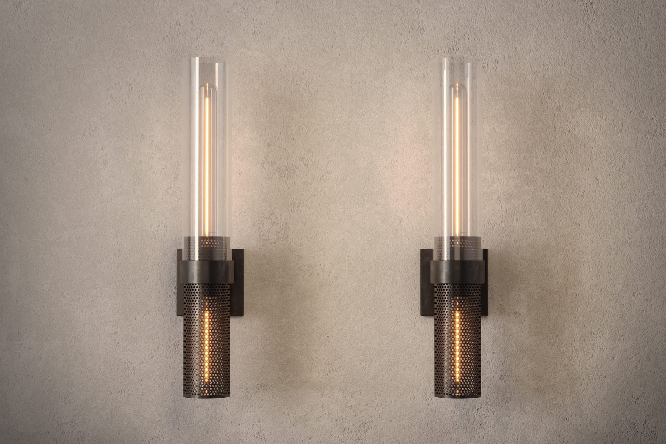Architectural lighting featuring two Carbide Sconce fixtures in hand-finished perforated metal and glass.