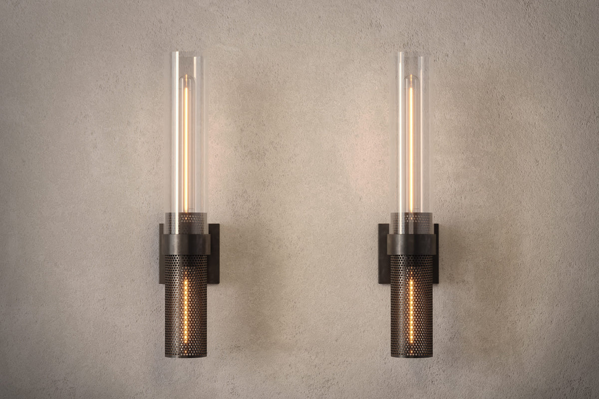 Front view of pair of designer Carbide Sconces, industrial-inspired wall lights featuring hand-finished perforated steel and heavy glass for genuine, utilitarian elegance.