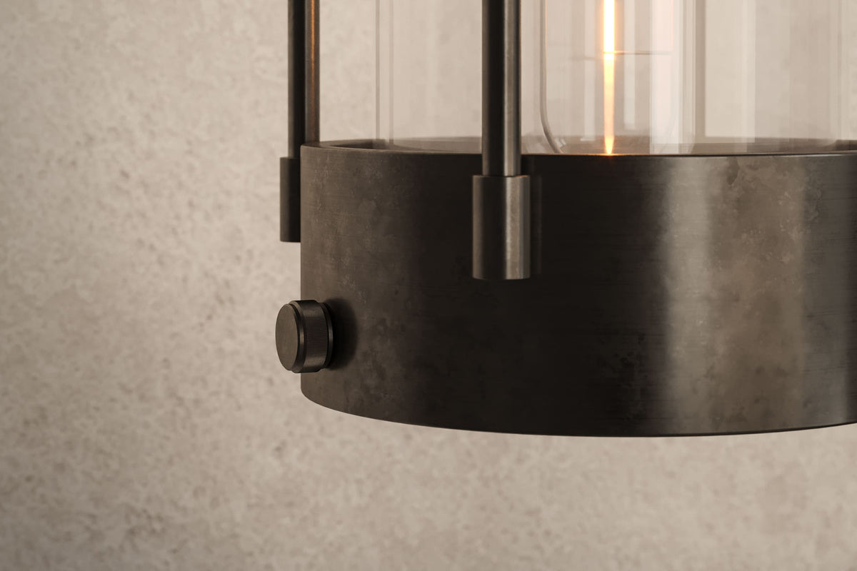 Close-up view of the designer Davy Sconce, an industrial-inspired decorative sconce featuring hand-finished perforated steel and heavy glass for genuine, utilitarian elegance.