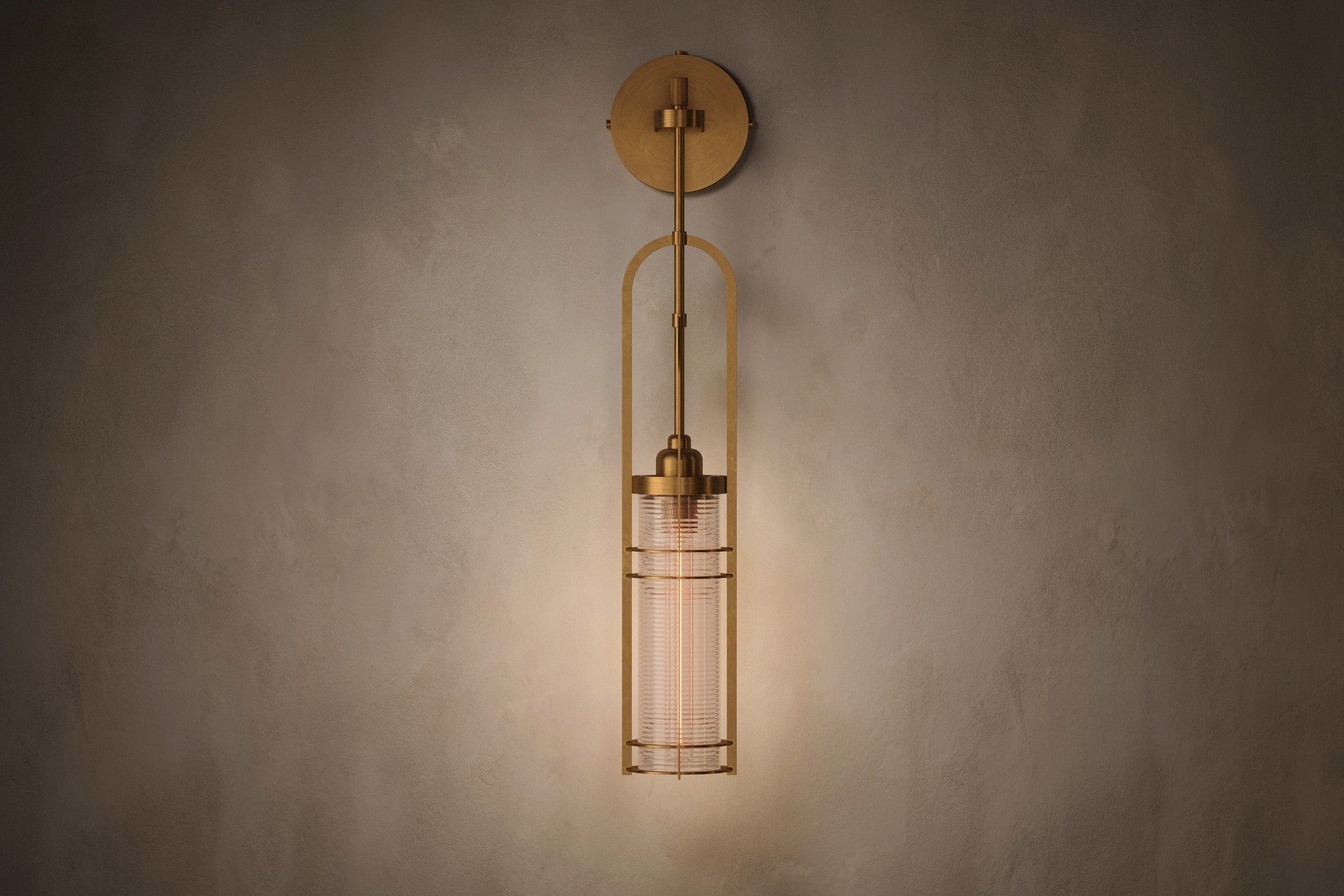 Modern designer lighting featuring the Halyard Axial Sconce, a wall sconce in hand-finished solid brass and glass.