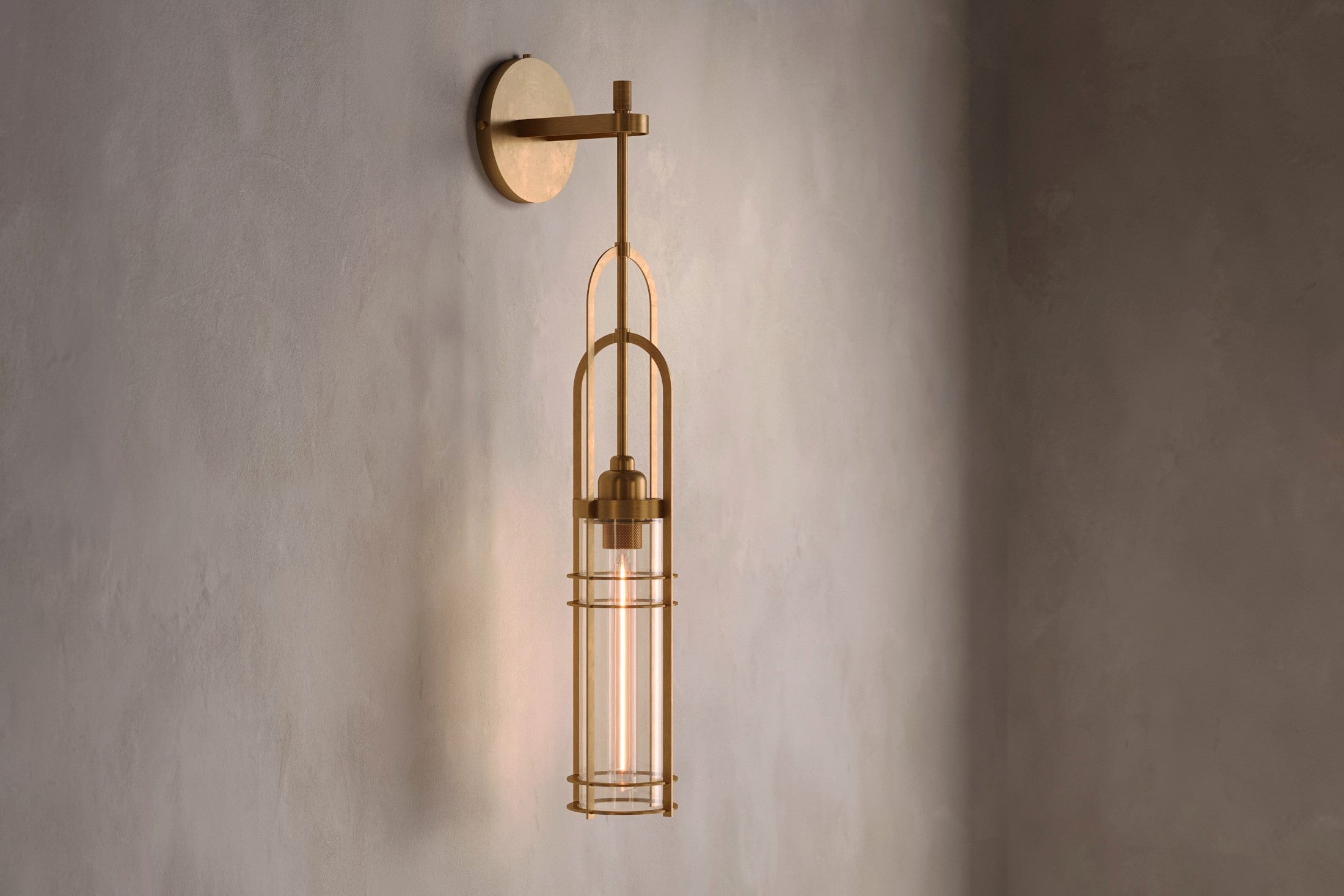 Architectural lighting featuring the Halyard Axial Sconce, a modern wall sconce in hand-finished solid brass and glass.