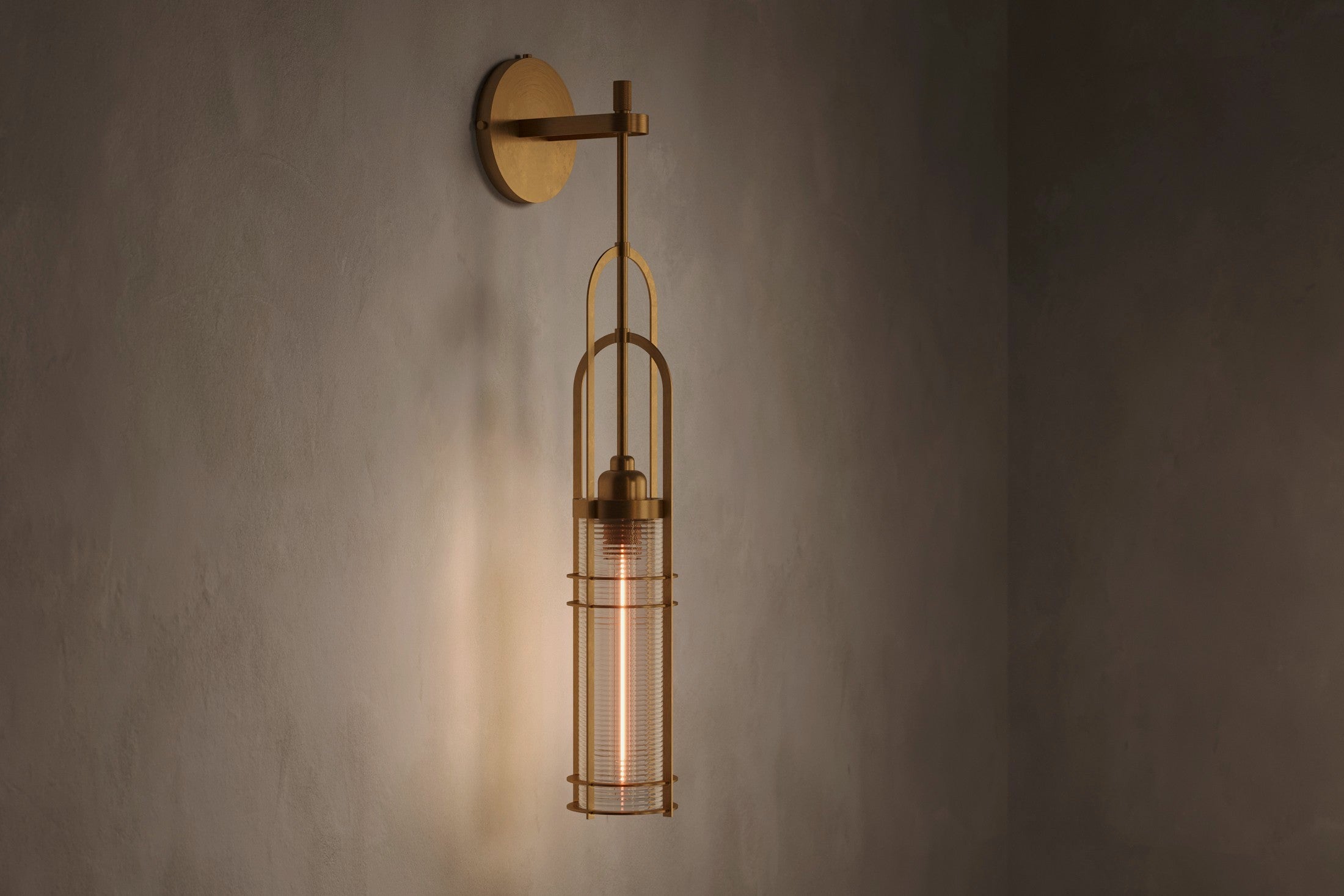 Modern architectural lighting featuring the Halyard Axial Sconce, a wall sconce in hand-finished solid brass and glass.