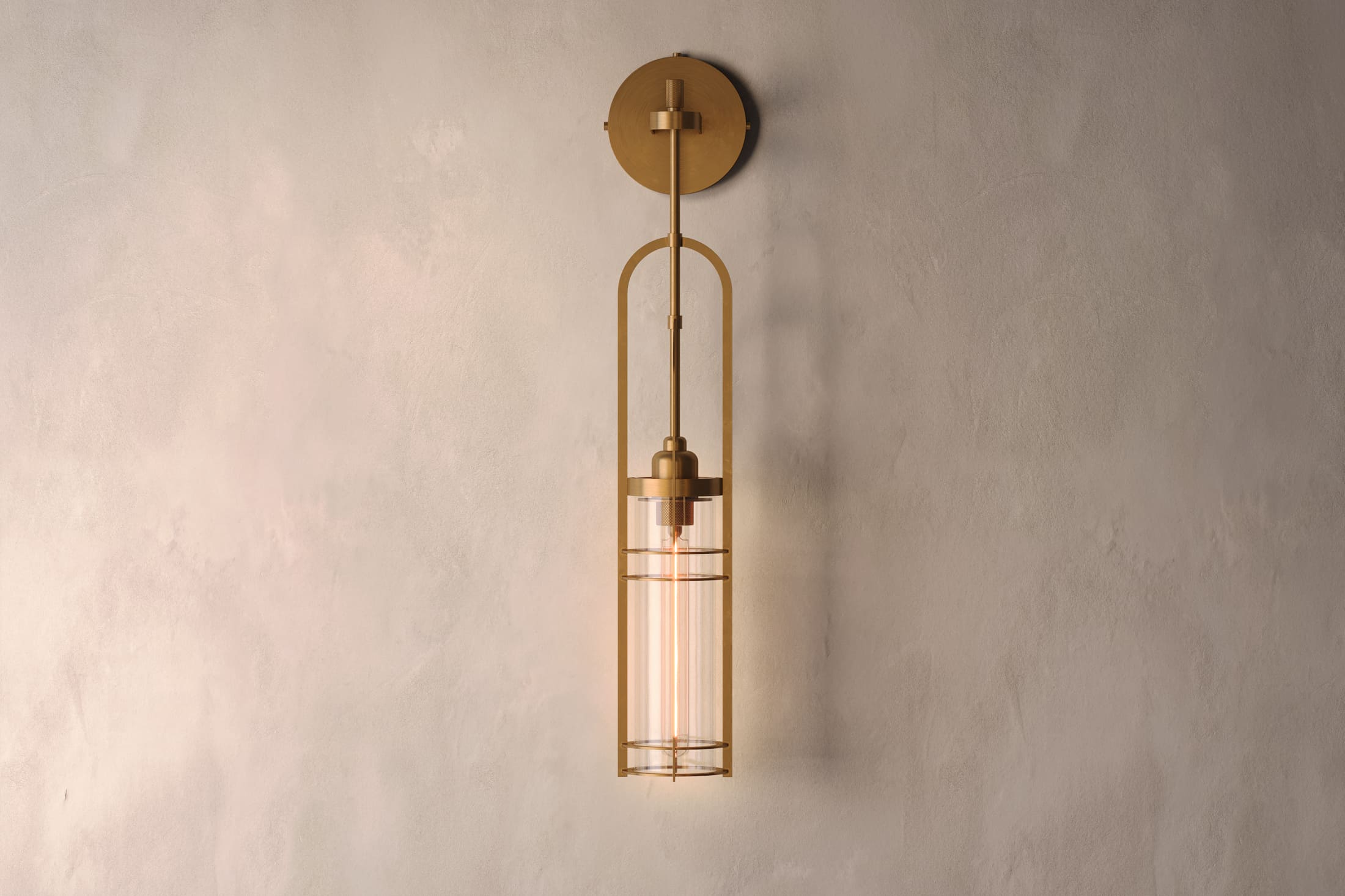 Designer lighting featuring the Halyard Axial Sconce, a modern wall sconce in hand-finished solid brass and glass.