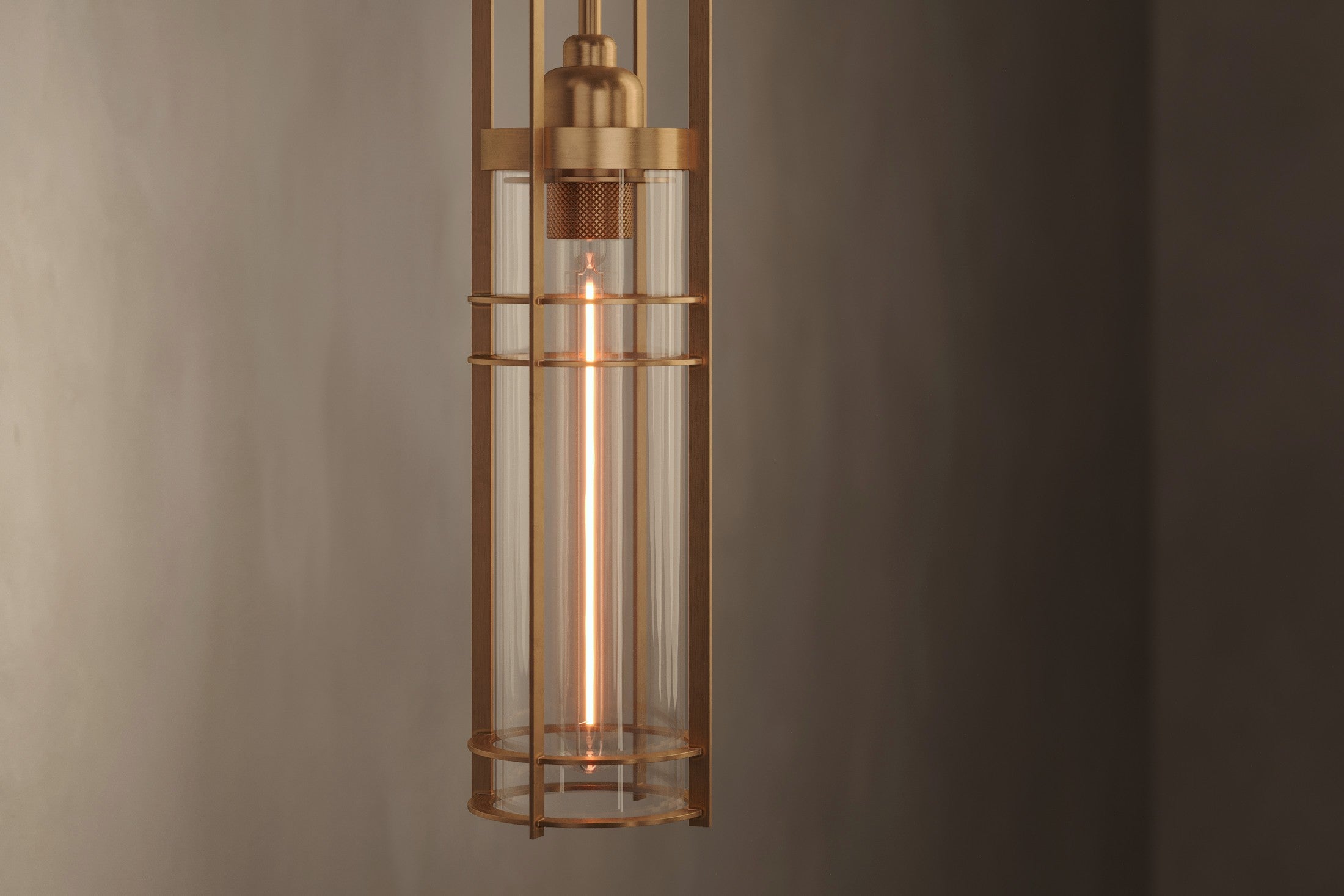 Close-up of the Halyard Pendant, a modern pendant light featuring hand-finished solid brass and glass.