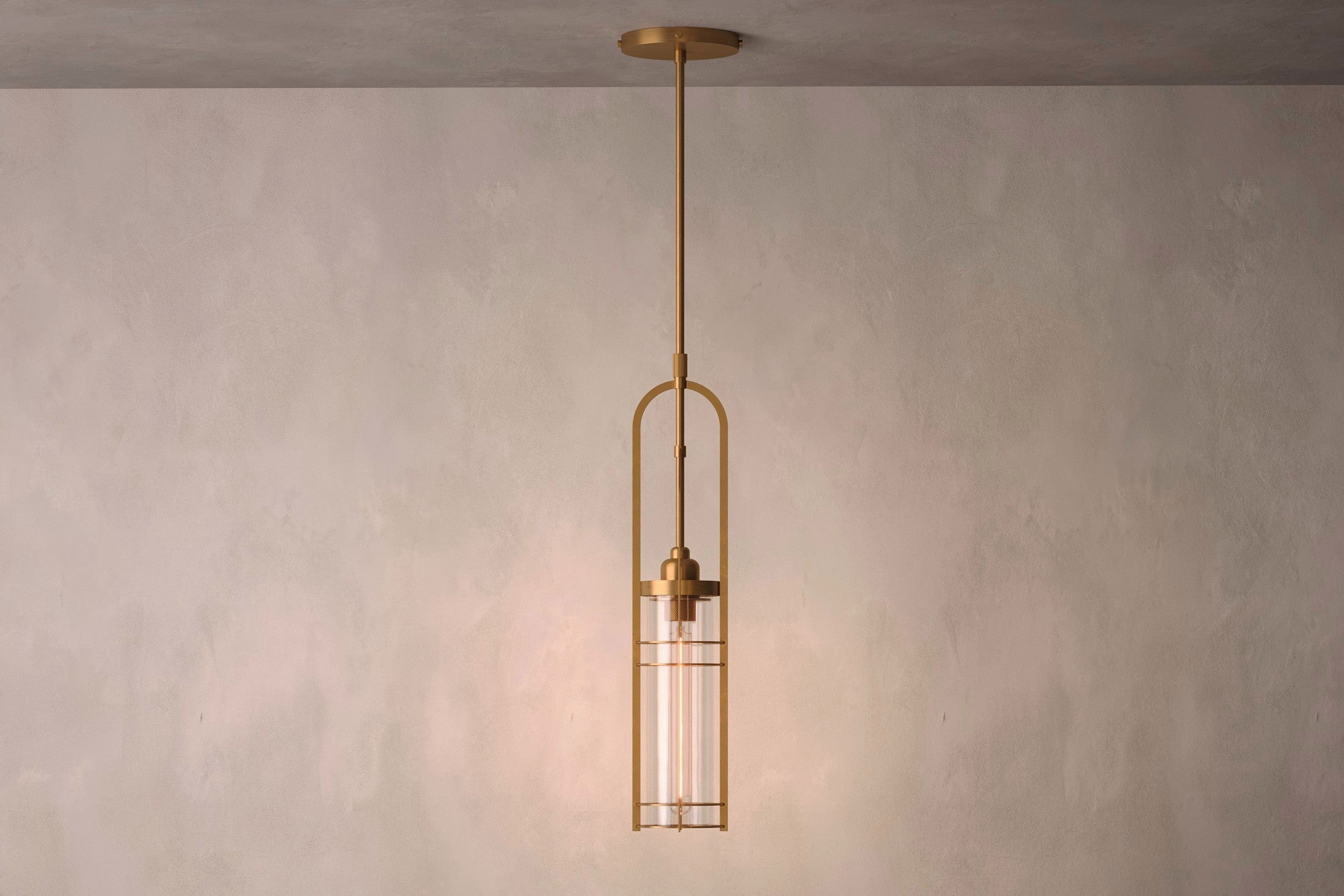 Designer lighting featuring the Halyard Pendant, a modern pendant light in hand-finished solid brass and glass.