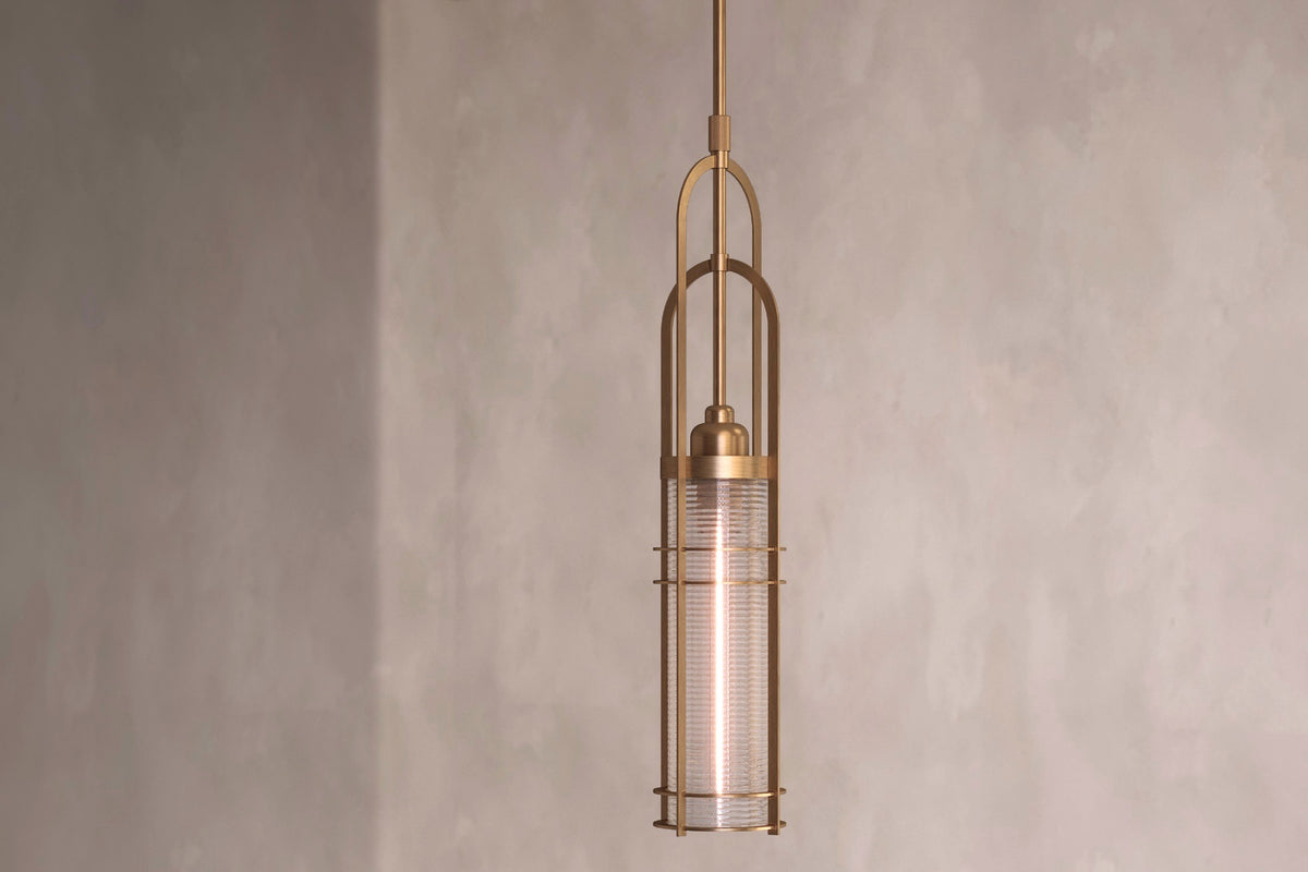 Angled view of the designer Halyard Pendant, a nautically-inspired pendant light featuring hand-finished solid brass and heavy glass for authentic, artisanal elegance.