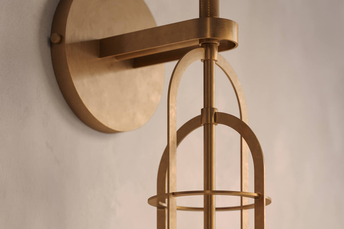 Close-up view of the architectural designer Halyard Sconce (Aura), a nautically-inspired wall light featuring hand-finished solid brass and heavy glass for authentic, artisanal elegance.