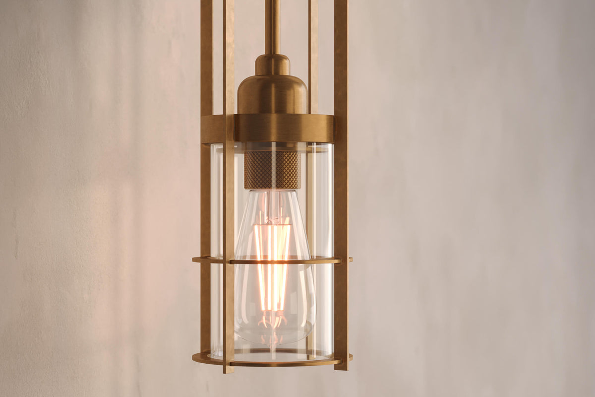 Close-up view of the modern designer Halyard Sconce (Aura), a nautically-inspired wall light featuring hand-finished solid brass and heavy glass for authentic, artisanal elegance.