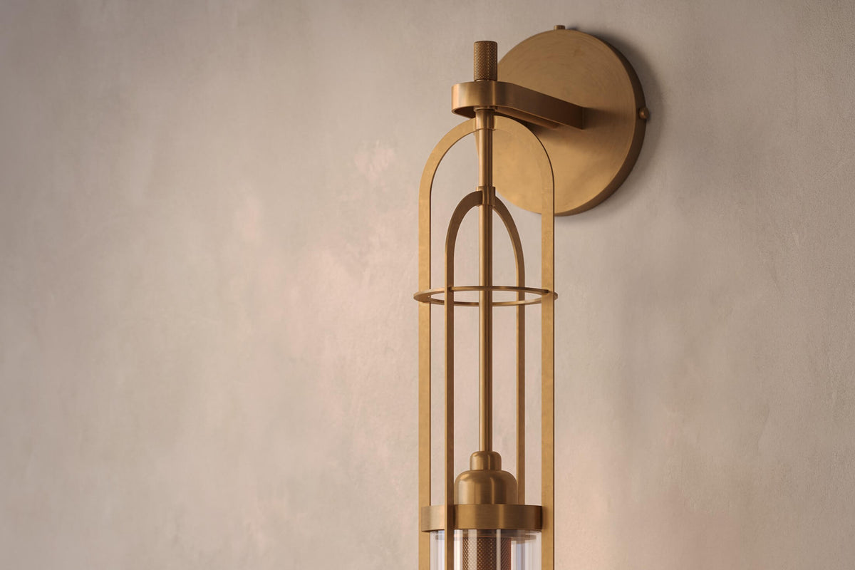 Close-up view of the designer Halyard Sconce (Aura), a nautically-inspired wall light featuring hand-finished solid brass and heavy glass for authentic, artisanal elegance.