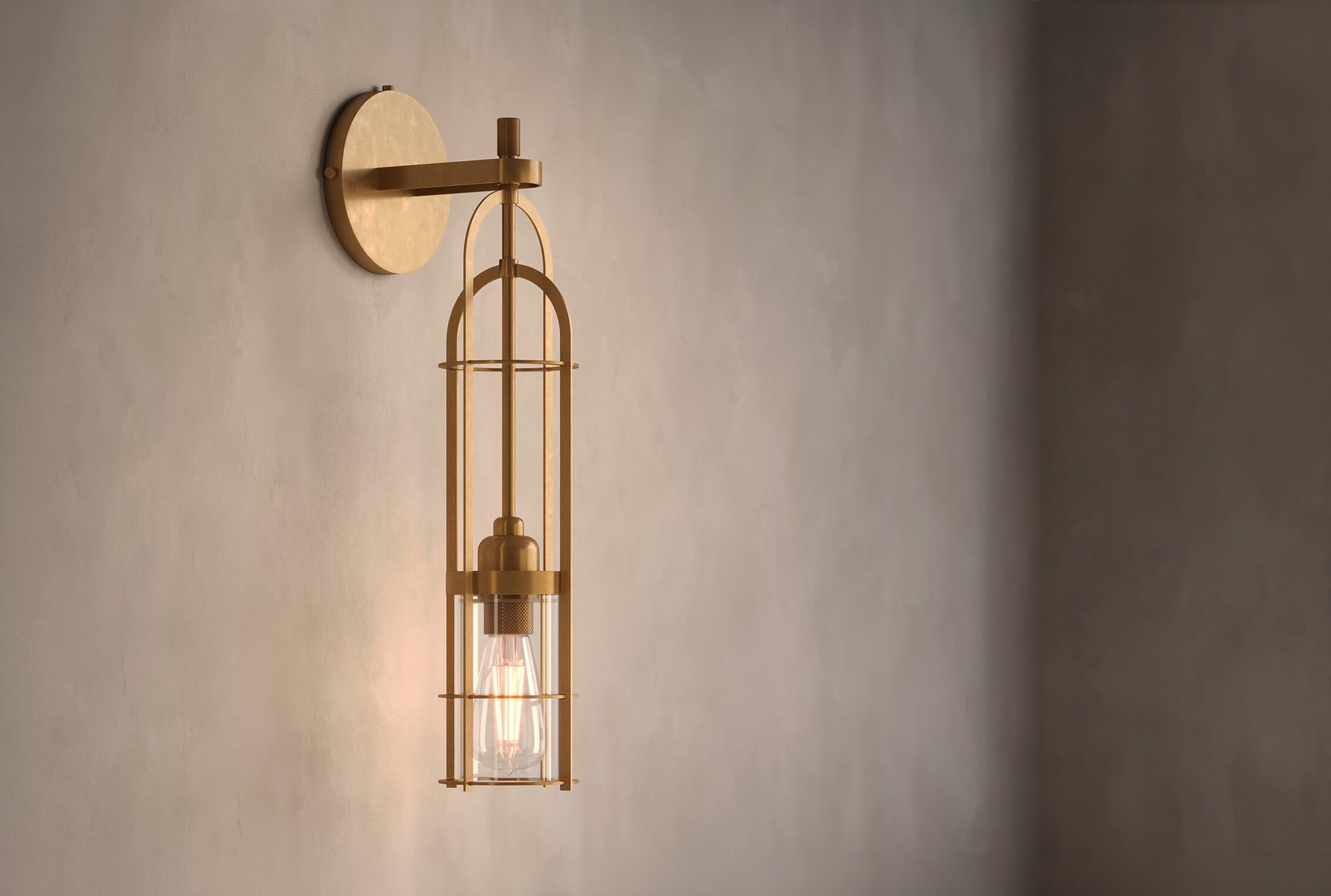 Angled view of the designer Halyard Sconce (Aura), a nautically-inspired wall light featuring hand-finished solid brass and heavy glass for authentic, artisanal elegance.