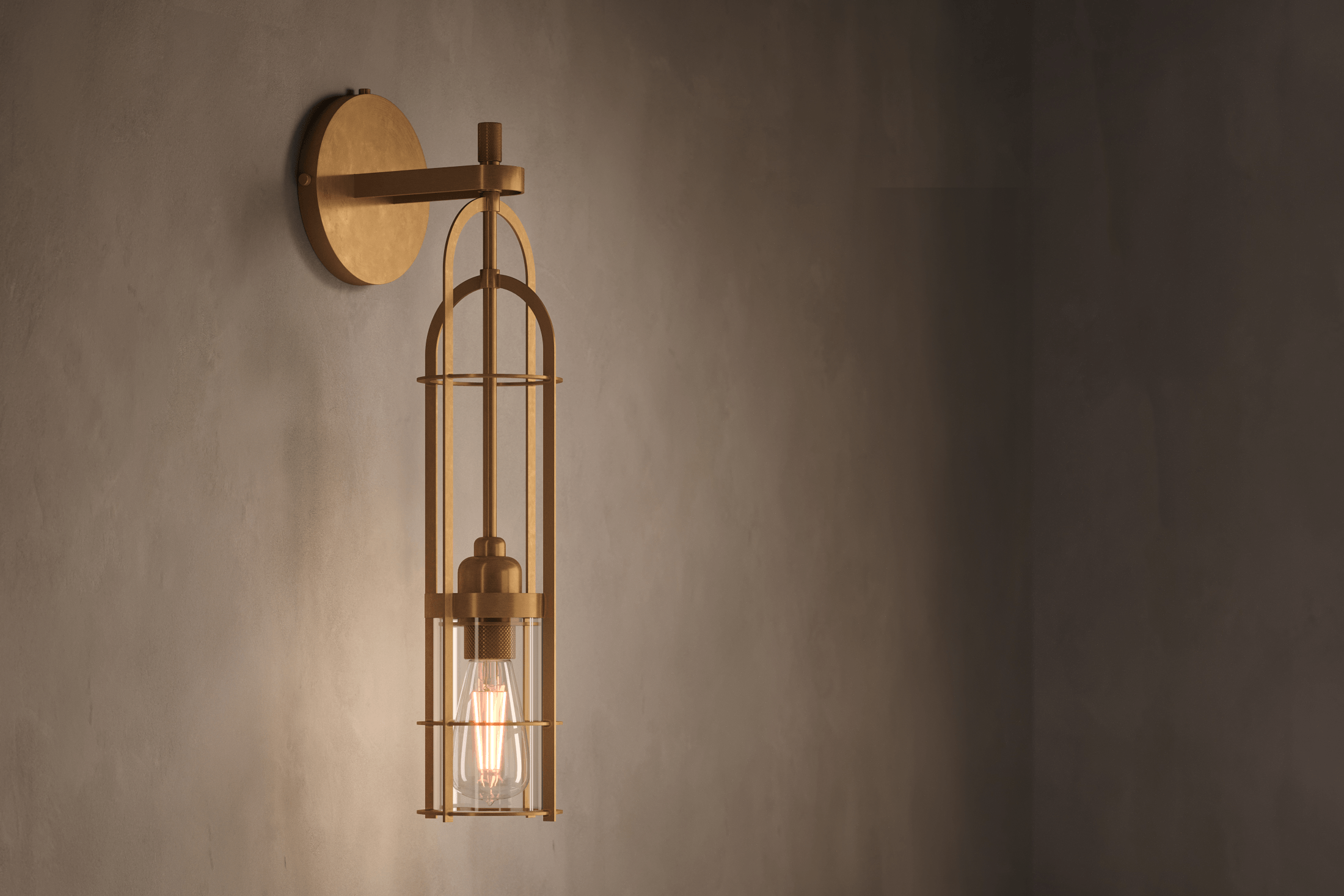 Angled view of the architectural designer Halyard Sconce (Aura), a nautically-inspired wall light featuring hand-finished solid brass and heavy glass for authentic, artisanal elegance.