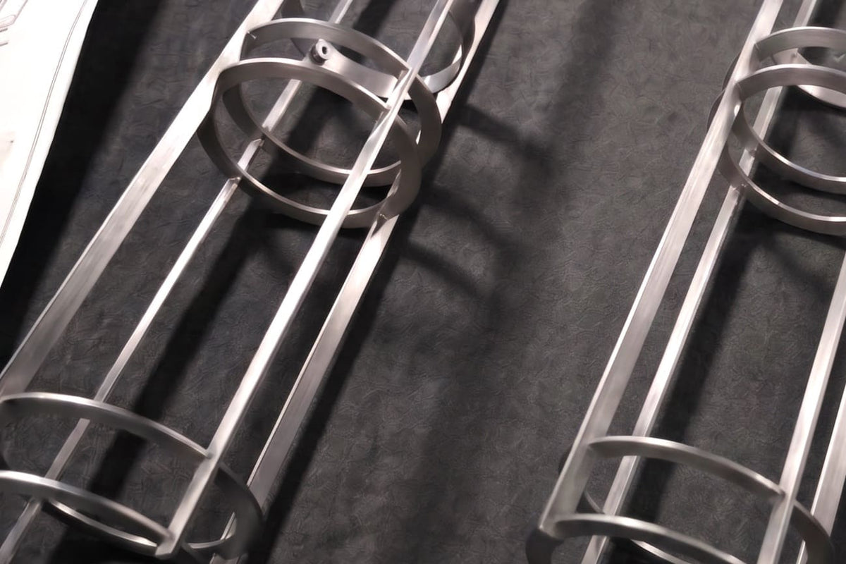 Metal lighting frames arranged in the Kimmel Crafted workshop.