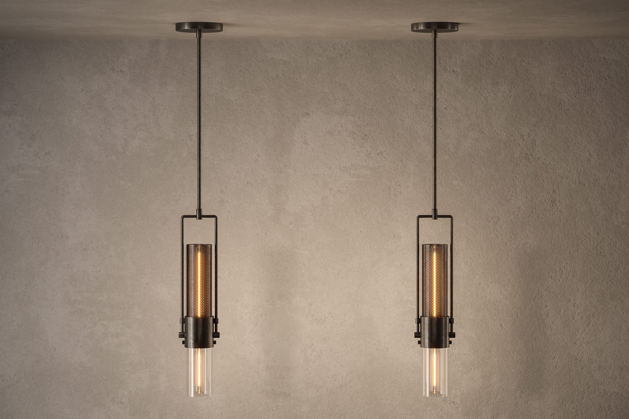 Decorative lighting featuring multiple Plumb Pendant fixtures in hand-finished steel and glass.