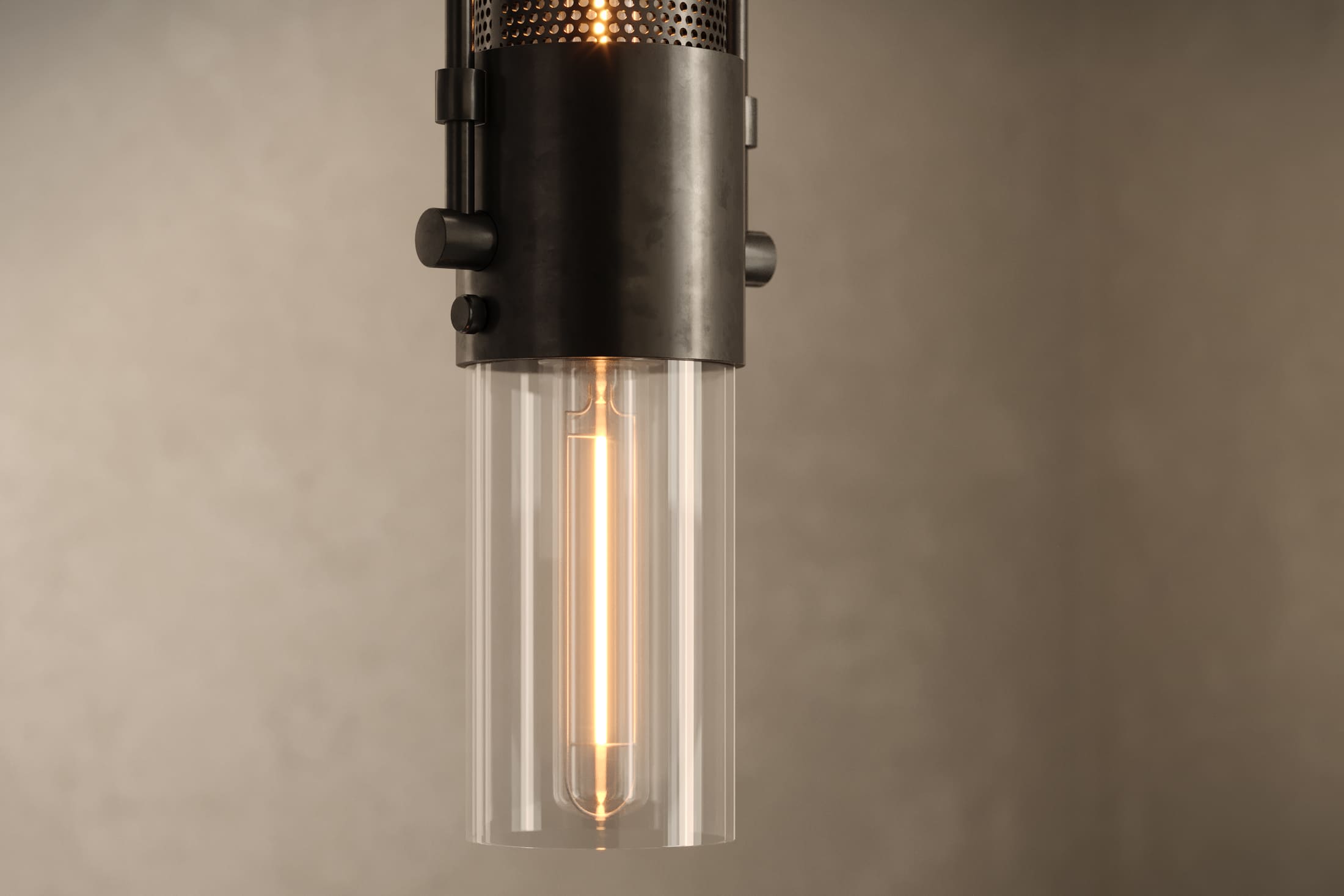 Close-up of the Plumb Pendant, a modern pendant light featuring hand-finished steel and glass.