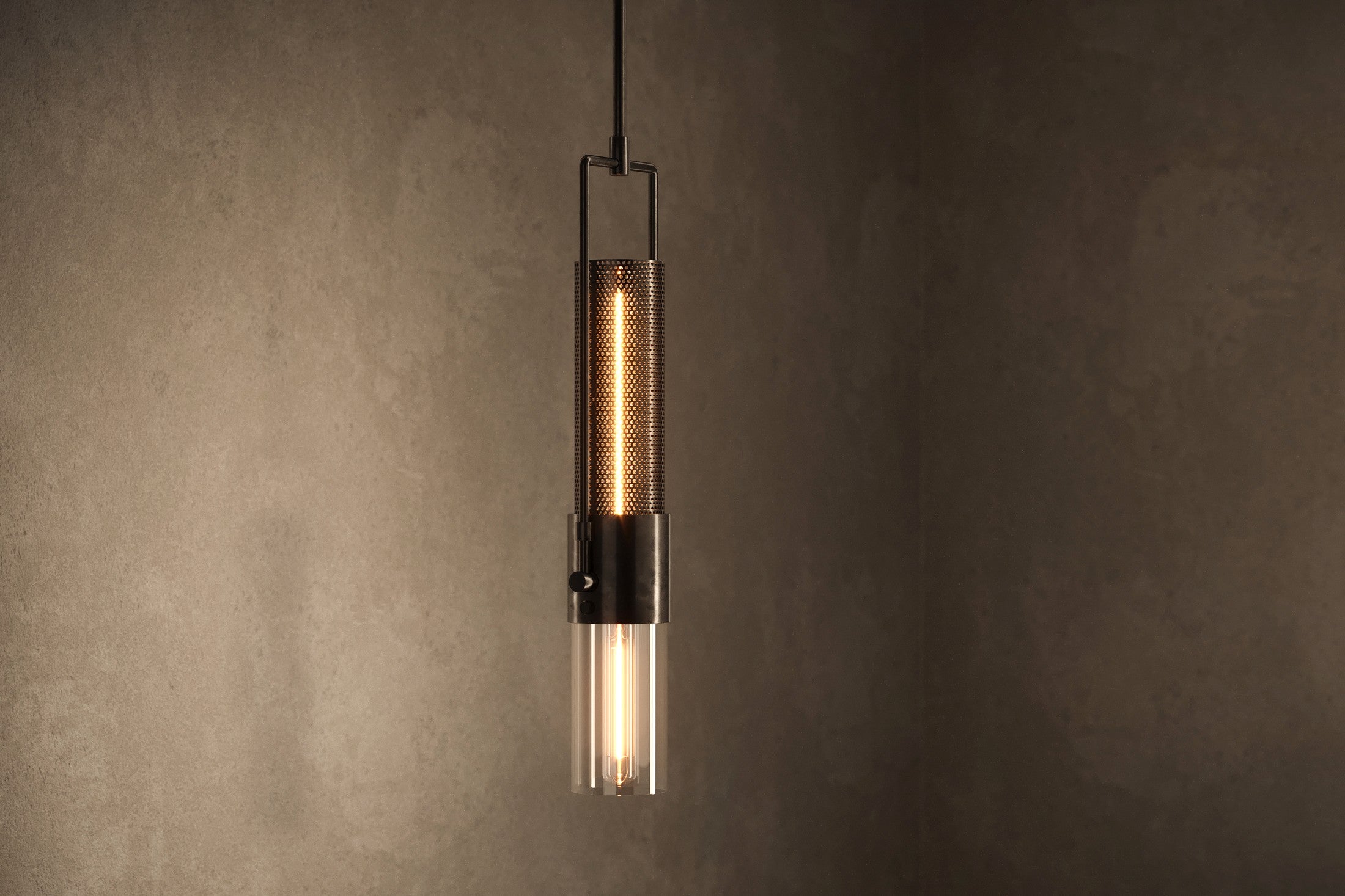 Modern architectural lighting featuring the Plumb Pendant, a pendant light in hand-finished steel and glass.