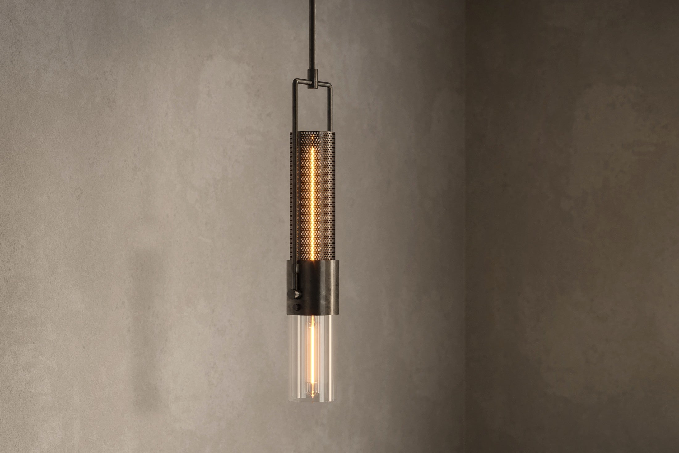 Close-up of the Plumb Pendant, a modern pendant light featuring hand-finished steel and glass.