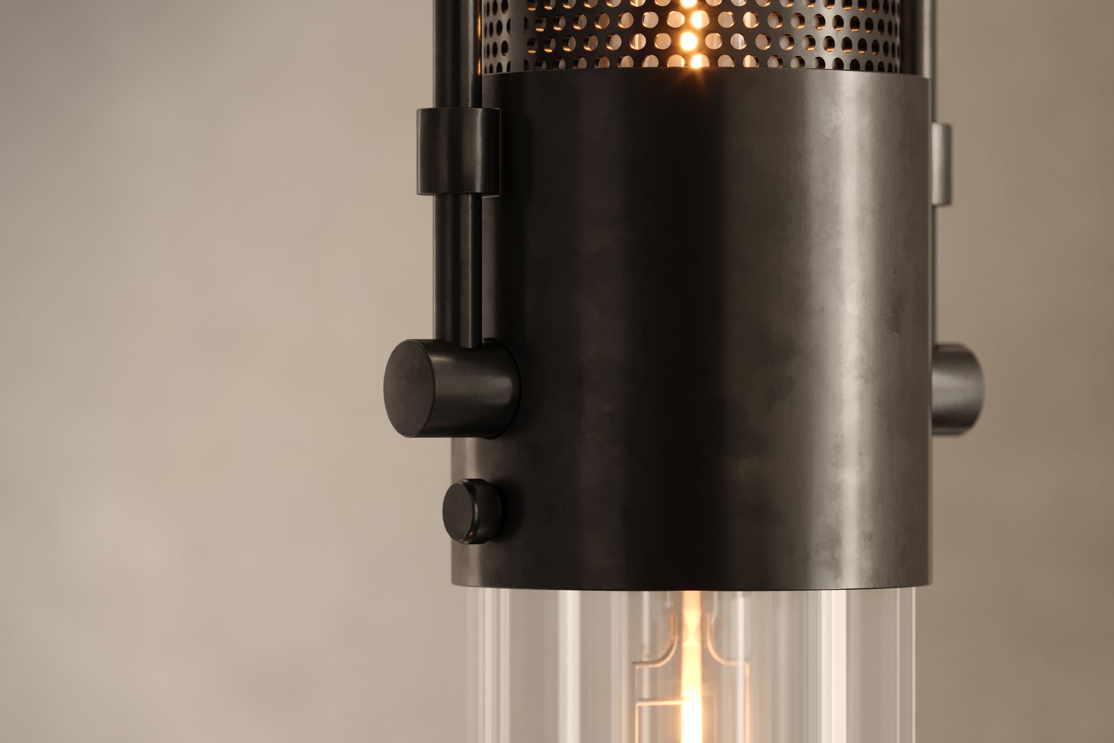 Close-up of the Plumb Pendant, a modern pendant light featuring hand-finished steel and glass.