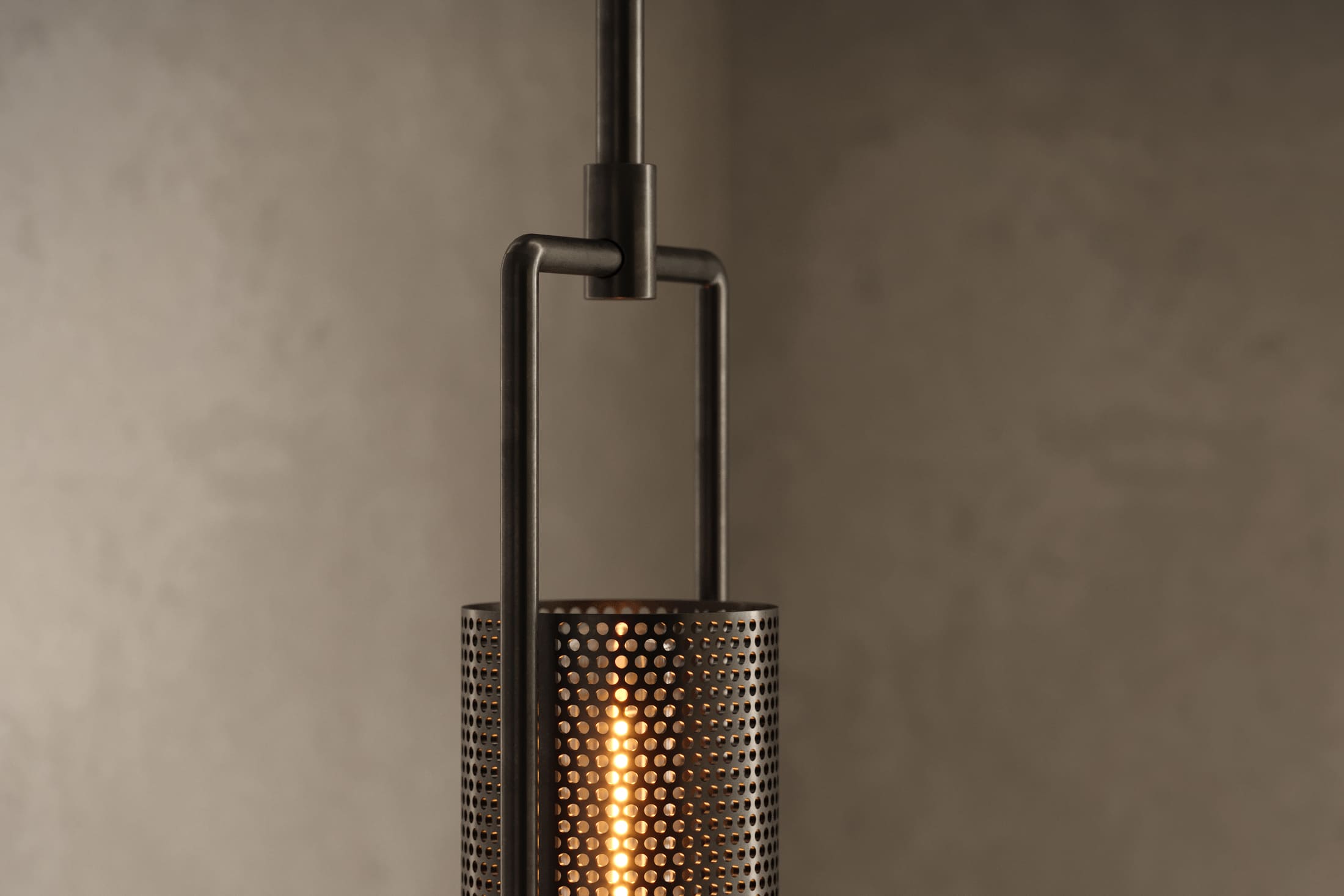 Close-up of the Plumb Pendant, a modern pendant light featuring hand-finished steel and glass.