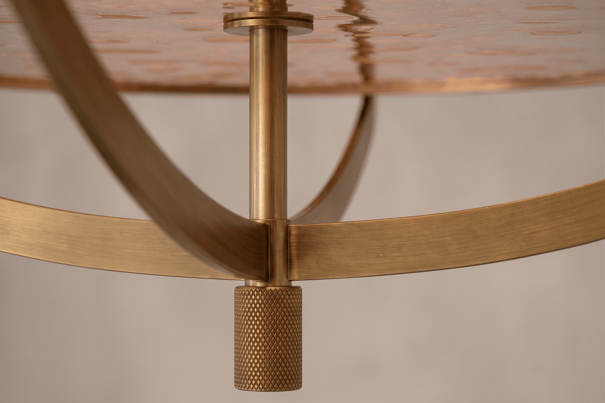 Close-Up view of the architectural designer Zenith Flush Mount, a nautically-inspired ceiling light featuring hand-finished solid brass and heavy glass for authentic, artisanal elegance.