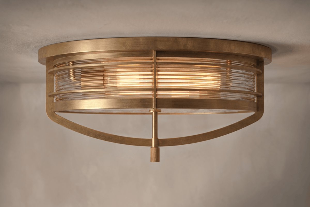 Front view of the designer Zenith Flush Mount, a nautically-inspired ceiling light featuring hand-finished solid brass and heavy glass for authentic, artisanal elegance.
